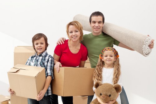 Movers transporting household items from a Southwark flat with stairs and lift access